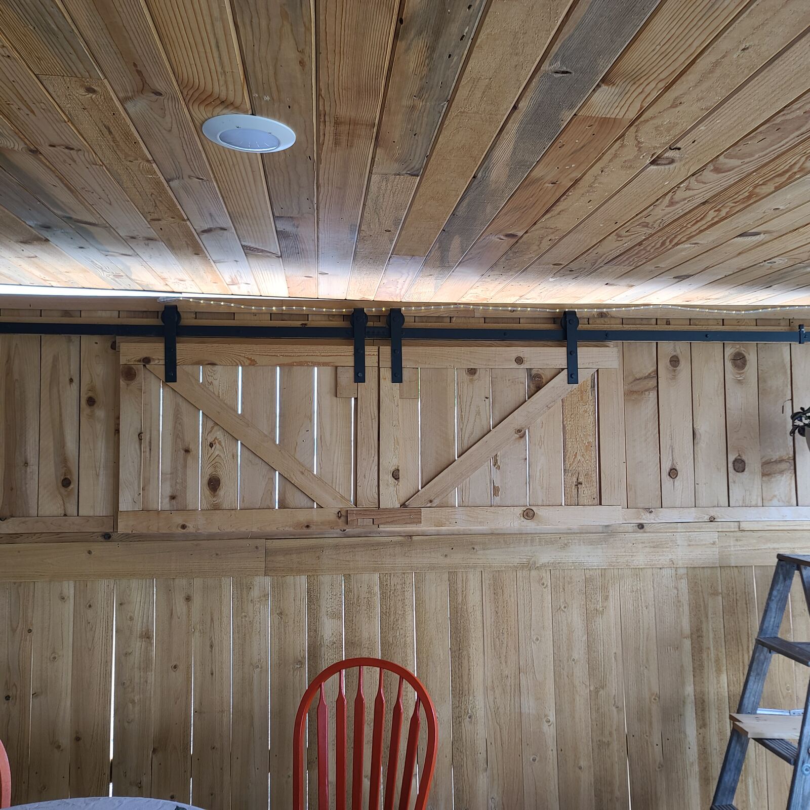 Interior wood wall with sliding barn door hardware installed