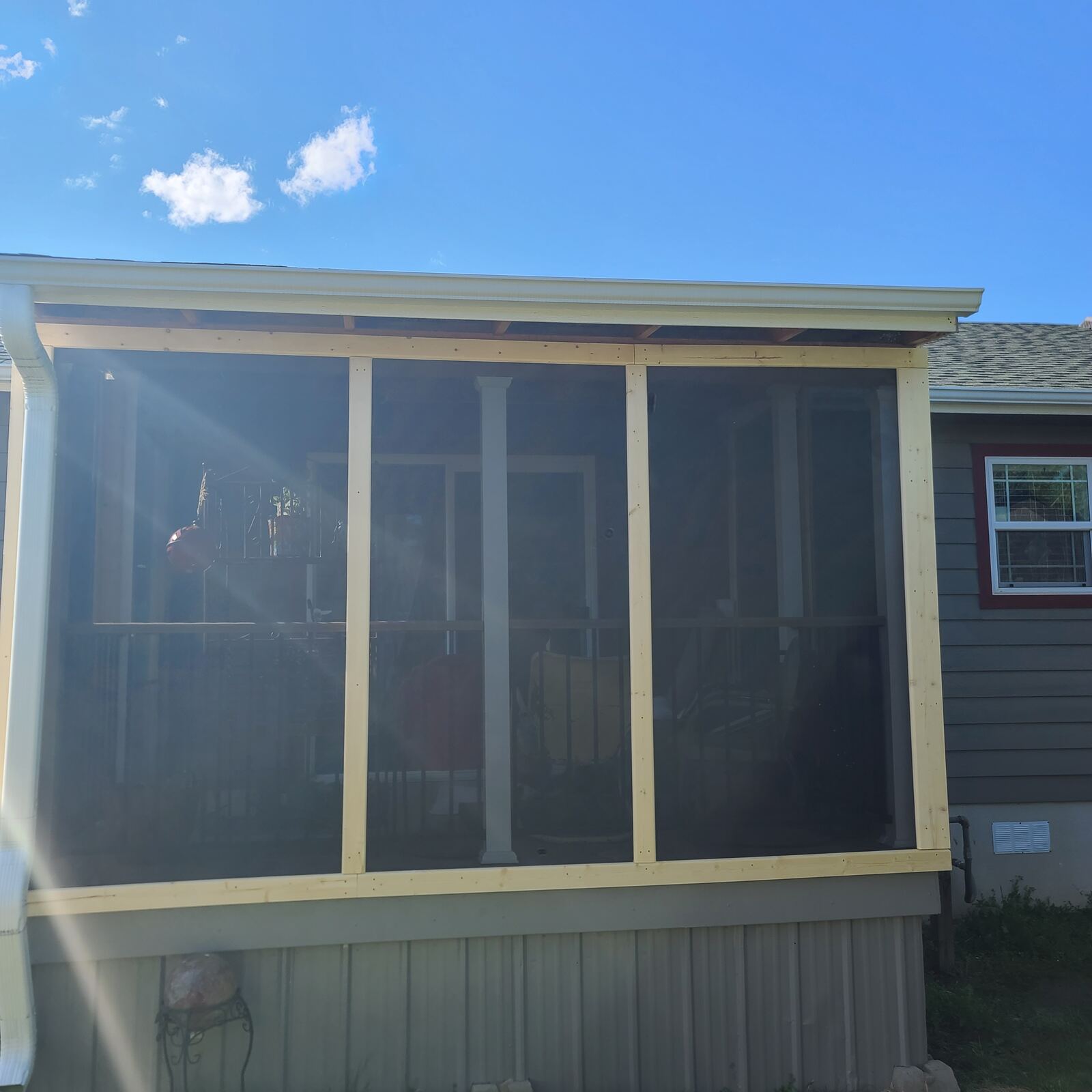 Screened porch addition, full wall view with wood framing