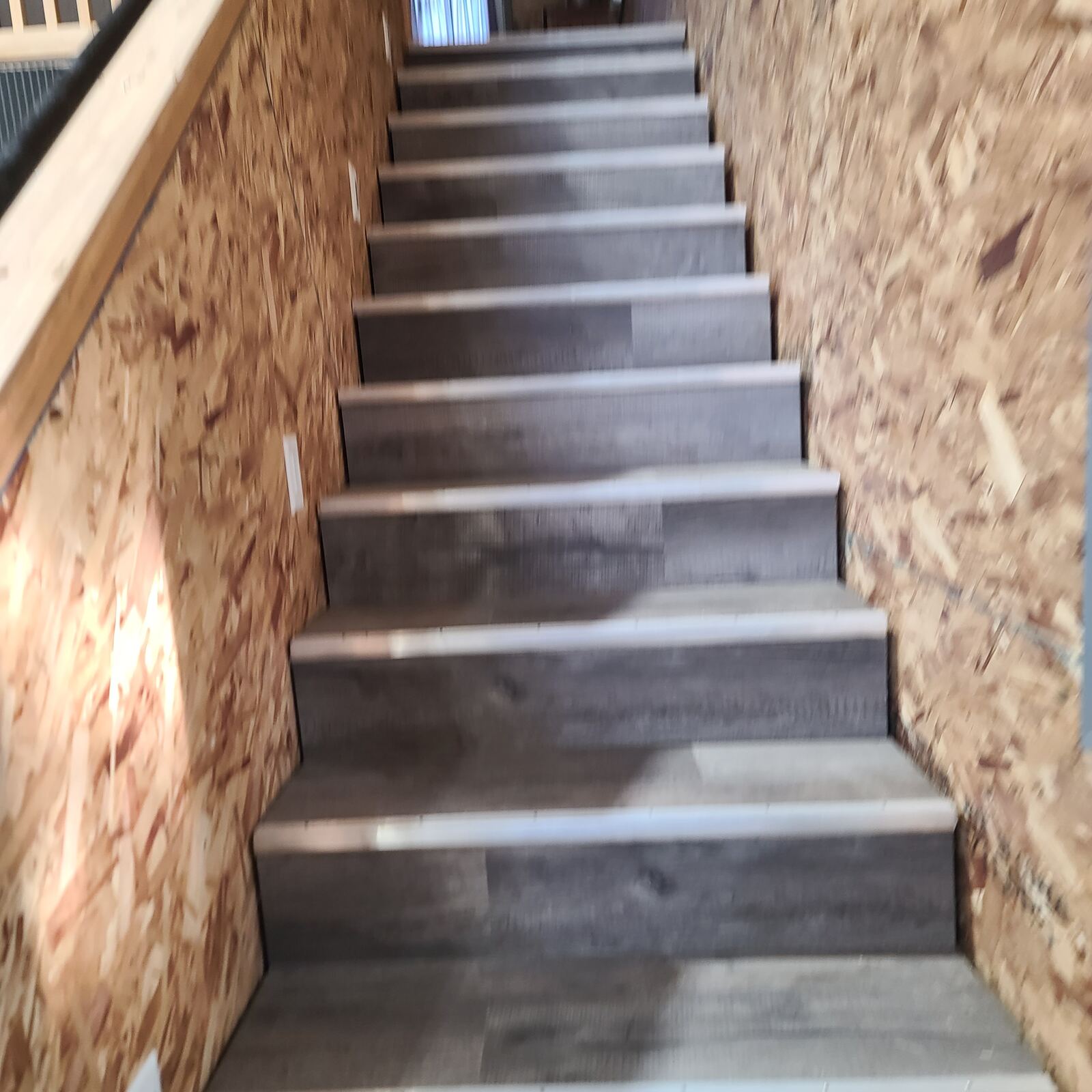 Staircase with new flooring installed on treads and risers
